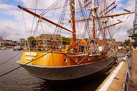 orange and gray boat at dock thumbnail