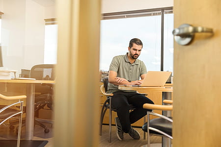 man sitting on chair using laptop thumbnail