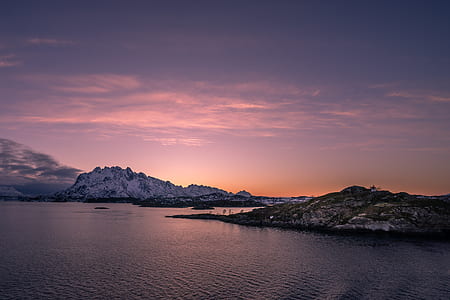 gray mountain near body of water at sunset thumbnail