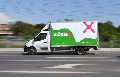 white and green box truck on road thumbnail