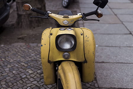 yellow motor scooter outdoor in tilt shift photography thumbnail