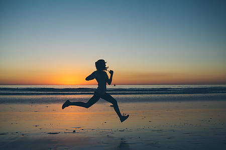 silhouette of person running near body of water thumbnail