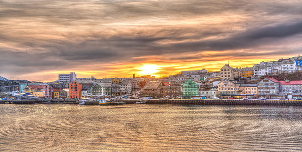 panoramic photography of city beside sea thumbnail