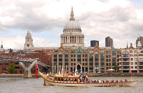 people paddling boat near beige concrete building with dome during daytime thumbnail