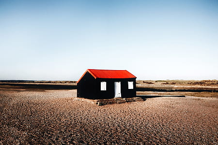 black wooden house on brown ground thumbnail