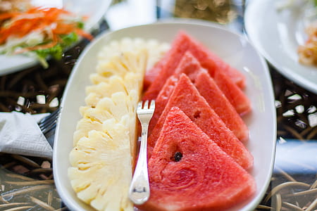 Sliced Watermelon and Pineapple Fruit With Stainless Steel Fork Placed on White Ceramic Rectangular Plate thumbnail