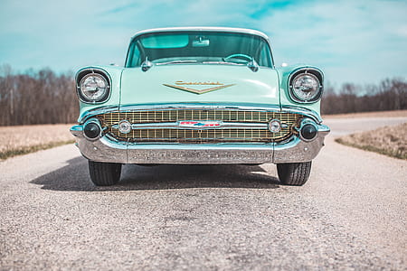 classic teal Chevrolet car on road thumbnail