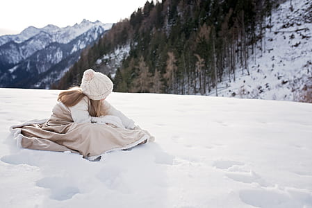girl in brown dress on snowy mountain during daytime thumbnail