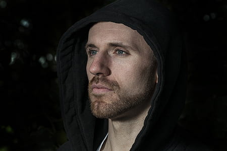 close-up photography of man wearing black hoodie thumbnail