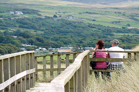 two person sitting on the bench during daytime thumbnail