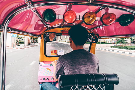 man riding autorickshaw on road thumbnail