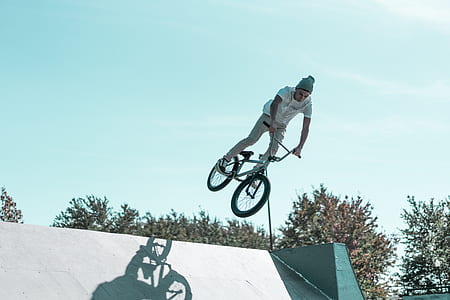 man riding on BMX bike doing tricks thumbnail