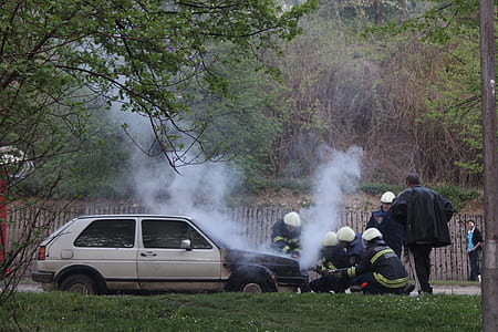 fireman beside white car thumbnail