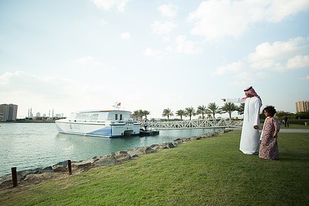 man and woman standing near body of water thumbnail