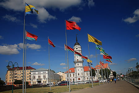 Different Flags Waving on Poles at Daytime thumbnail