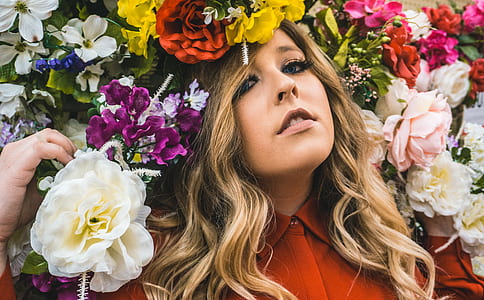 woman posing near flowers during daytime thumbnail