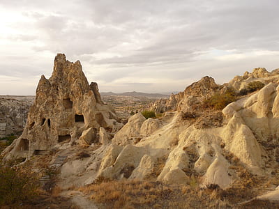 caves on mountains under cloudy sky thumbnail