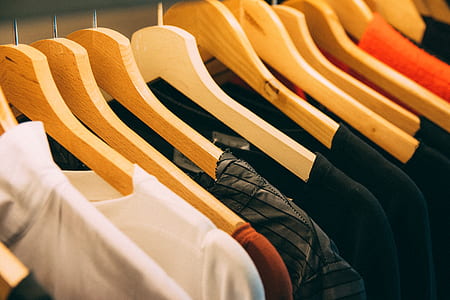 selective focus photography of assorted-color shirts and clothes hanger thumbnail