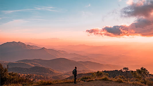 person standing near mountain thumbnail