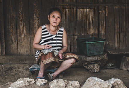 woman sitting beside green plastic basket thumbnail