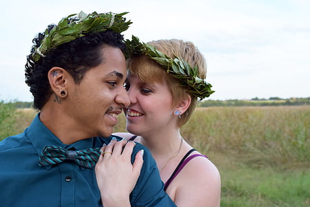 woman hugging man in grass field thumbnail