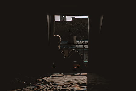 silhouette of person sitting on window thumbnail