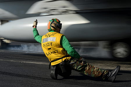 man under gray plane thumbnail
