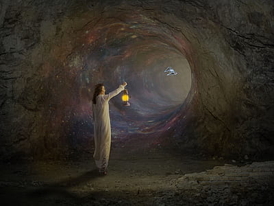 person holding lamp inside cave thumbnail