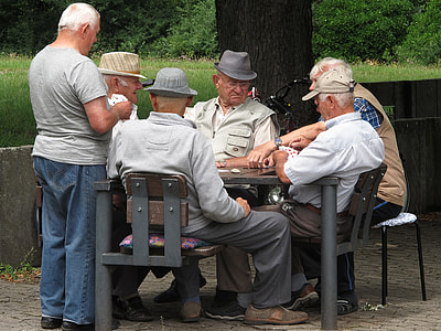men sitting and standing by the table at daytime thumbnail