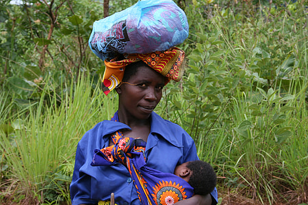 woman wearing blue dress breastfeeding baby thumbnail