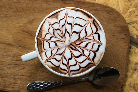 black spoon beside white cup thumbnail