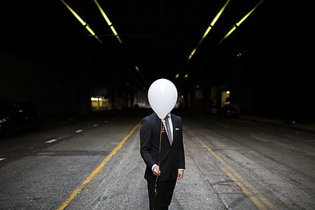 men in black suit jacket on road thumbnail