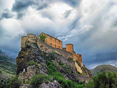 brown concrete castle on top of the mountain thumbnail