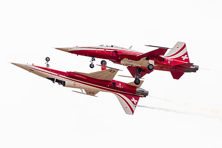 two flying red-and-beige aircrafts thumbnail