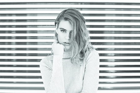 grayscale photography of woman wearing sweater thumbnail