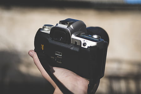 person holding black DSLR camera thumbnail