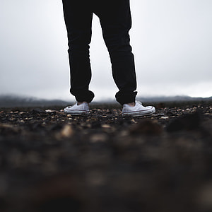 selective focus photography of man standing on soil thumbnail