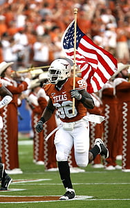 football player holding USA flag while running thumbnail