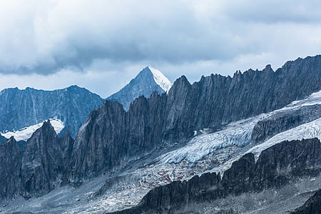 snow covered rocky mountain during daytime thumbnail