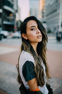 woman wearing white and black t-shirt standing closeup photography thumbnail
