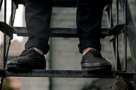 person wearing black Vans Authentic on black wrought iron stair thumbnail