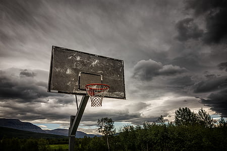 basketball hoop under gray clouds thumbnail