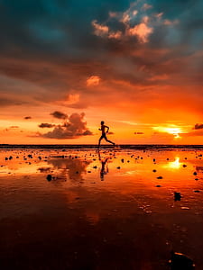 silhouette photo of person running near seashore thumbnail
