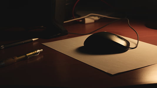 black corded mouse on top of white mouse pad thumbnail