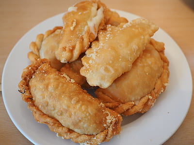 empanadas on white ceramic saucer thumbnail