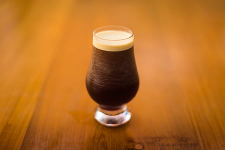 filled coffee clear glass on top of wooden surface thumbnail