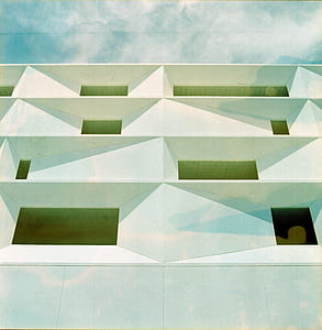 low angle photography of white concrete building during daytime thumbnail