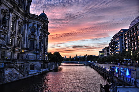 silhouette photography of body of water between buildings thumbnail