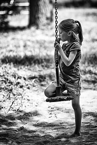 grayscale photography of girl riding swing chair thumbnail