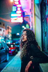 portrait photography of curly haired woman thumbnail